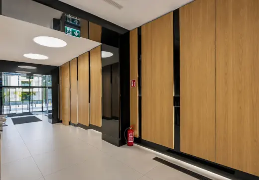 Biuro Krucza wynajem, elegancki korytarz z drewnianymi panelami i wejściem do centrum biurowego