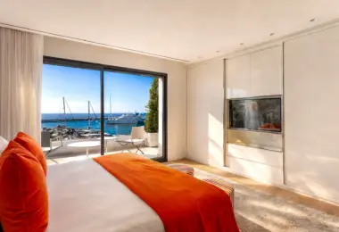 Apartment for sale Marbella Spain – Puerto Banús luxury bedroom with marina view terrace and Mediterranean sea panorama