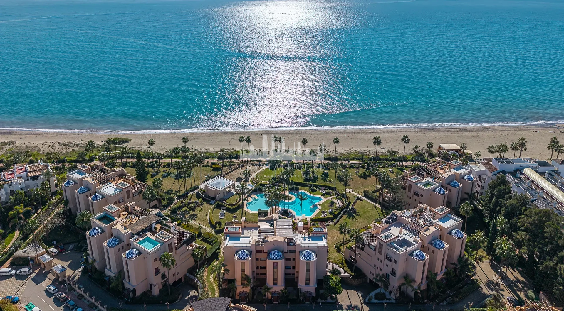 Luxury beachfront apartment in Estepona seaside residence with pool, palm gardens and beach access