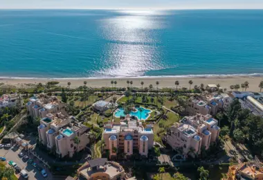 Luxury beachfront apartment in Estepona seaside residence with pool, palm gardens and beach access