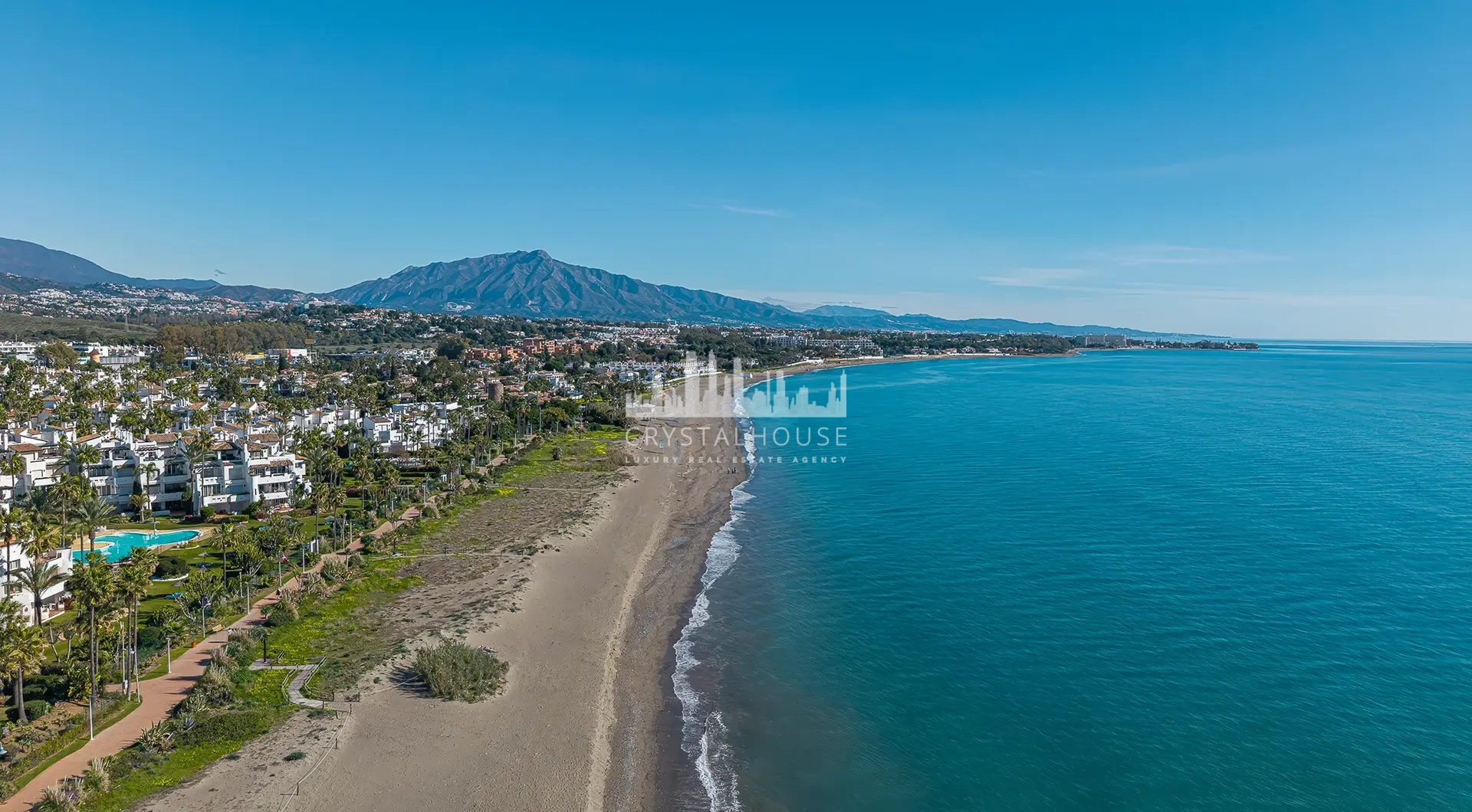 Luxury beachfront apartment in Estepona coastal view with sandy beach and seaside apartments