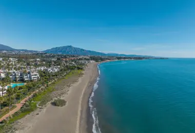 Luxury beachfront apartment in Estepona coastal view with sandy beach and seaside apartments