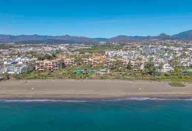 Luxury beachfront apartment in Estepona coastal residential complex with pool and mountain views