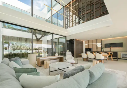 Luxury villa Marbella Golden Mile open plan living and dining area with double height ceiling and glass walls